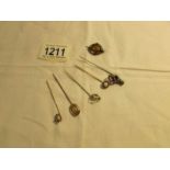 6 Victorian stick pins and a brooch.