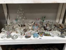 A shelf of small glass ornaments, animals, angels & fairies etc.