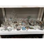 A shelf of small glass ornaments, animals, angels & fairies etc.
