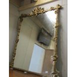 A gilded over mantel mirror.