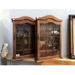 A pair of wall display cabinets