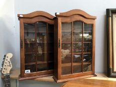 A pair of wall display cabinets