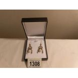 A pair of pearl drop earrings set with diamonds,