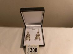 A pair of pearl drop earrings set with diamonds,