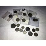 16 silver coins, most with holes, approximately 46 grams.