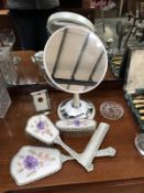 A matching vanity set (brush, mirror, comb, clothes brush) plus a mirror,