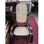 A rocking chair with bergere seat and back