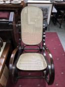 A rocking chair with bergere seat and back