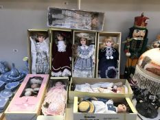 A collection of 9 boxed porcelain dolls