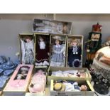 A collection of 9 boxed porcelain dolls