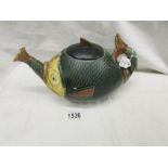 An unusual fish shaped teapot.