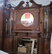 A magnificent mahogany fire surround with over mantle mirror and side cabinets.