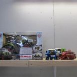 3 unboxed Shell farm vehicles and a boxed radio controlled Claas Axiion 850 tractor.