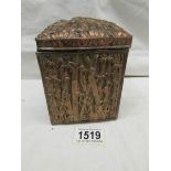 A Chinese metal tea caddy with bamboo decoration.