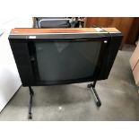 A Bang & Olufson Beovision LX2500 TV on trolley stand