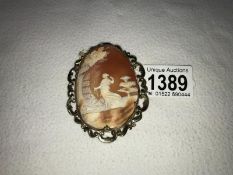 A large impressive 19th century oval cameo of a young woman with her dog in a landscape set in a