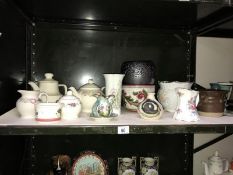 A shelf of pottery items including planters etc.