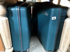 2 hard plastic suitcases on wheels