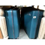 2 hard plastic suitcases on wheels