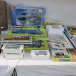 A box of carriages, buildings and model kit boxes.