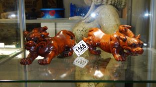 A pair of carved wood Chinese dragons,