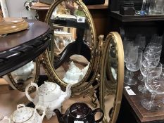 A dressing table triptych mirror in gold frame and a gold patinated standard lamp