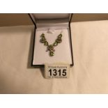 A necklace set with peridot, seed pearls and diamonds,