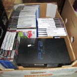 A Playstation 2 computer console with assortment of games.