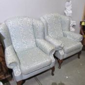 A pair of wing armchairs.