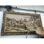 A framed tapestry depicting a hunting scene