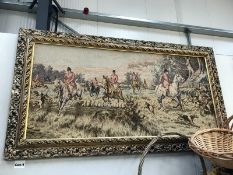 A framed tapestry depicting a hunting scene