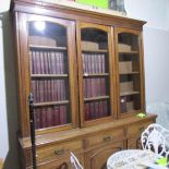 An oak glazed top 3 door bookcase.