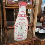 A 'Fresh Milk Daily' advertising wall clock.