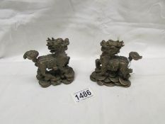 A pair of small heavy brass Chinese dragons,.