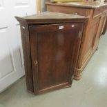 An oak corner cupboard.