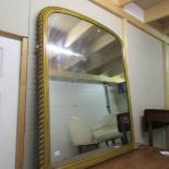 A gilded over mantel mirror.