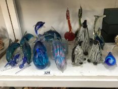 A collection of glass figurines including penguin family group