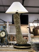 A retro leopard boot table lamp