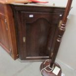 An oak corner cupboard.