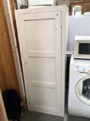 A white painted kitchen storage cabinet