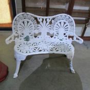 A 2 seat metal garden bench.