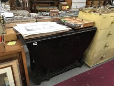 An oval drop leaf table