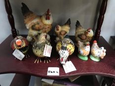 A shelf of chicken ornaments and salt and peppers