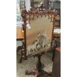 A Victorian rosewood fire screen with glazed tapestry panel.
