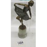 An art deco ballerina figure on marble base.