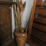 A pot on stand with various bamboo poles.