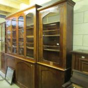 A huge mahogany break front book case.