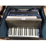 A piano accordian with case