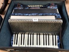 A piano accordian with case