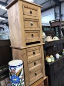 A pair of pine bedside chests of drawers